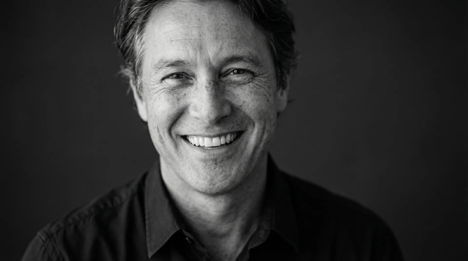 Close-up of a smiling woman with closed eyes, freckles, and overlaid facial measurement lines and circles.