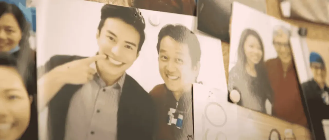 Close-up of pinned photos on a board showing smiling people posed for pictures with Dr. Jerry and Dr. Yap