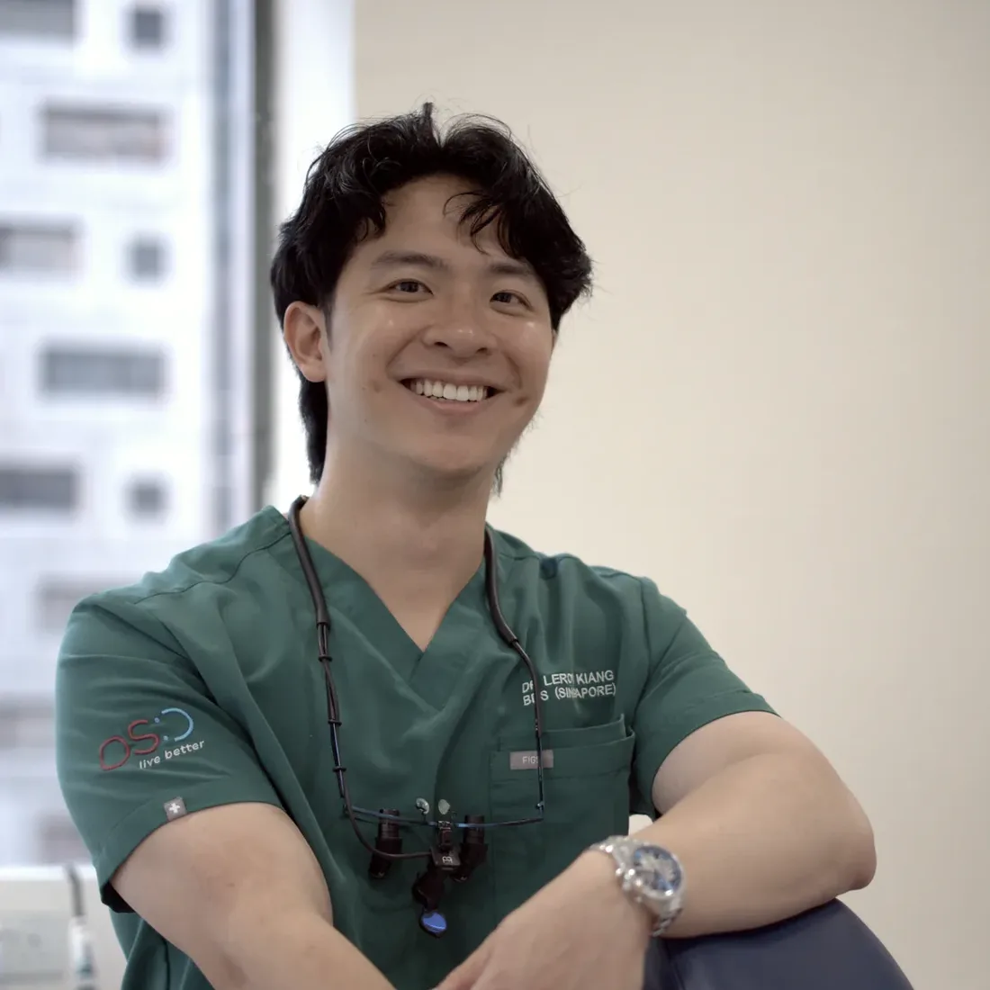 Dr Leroy Kiang leaning on the dental chair at Orchard Scotts Dental, Singapore