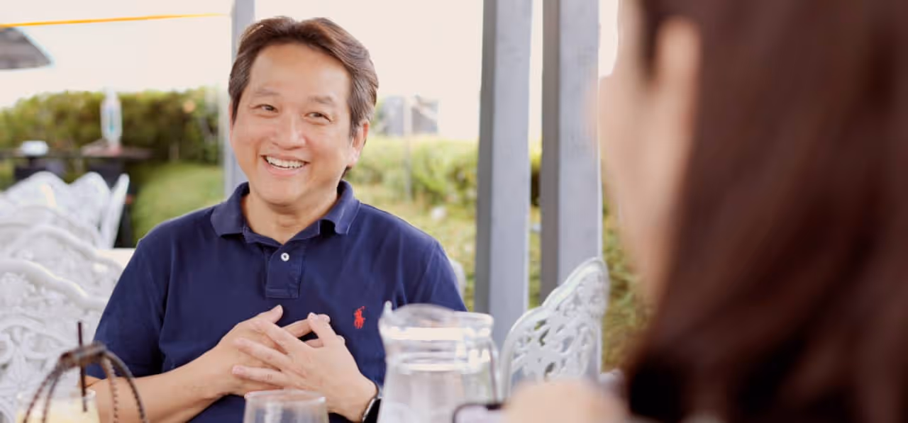 Dr. Jerry Lim outside in conversation with HBR hands on heart smiling