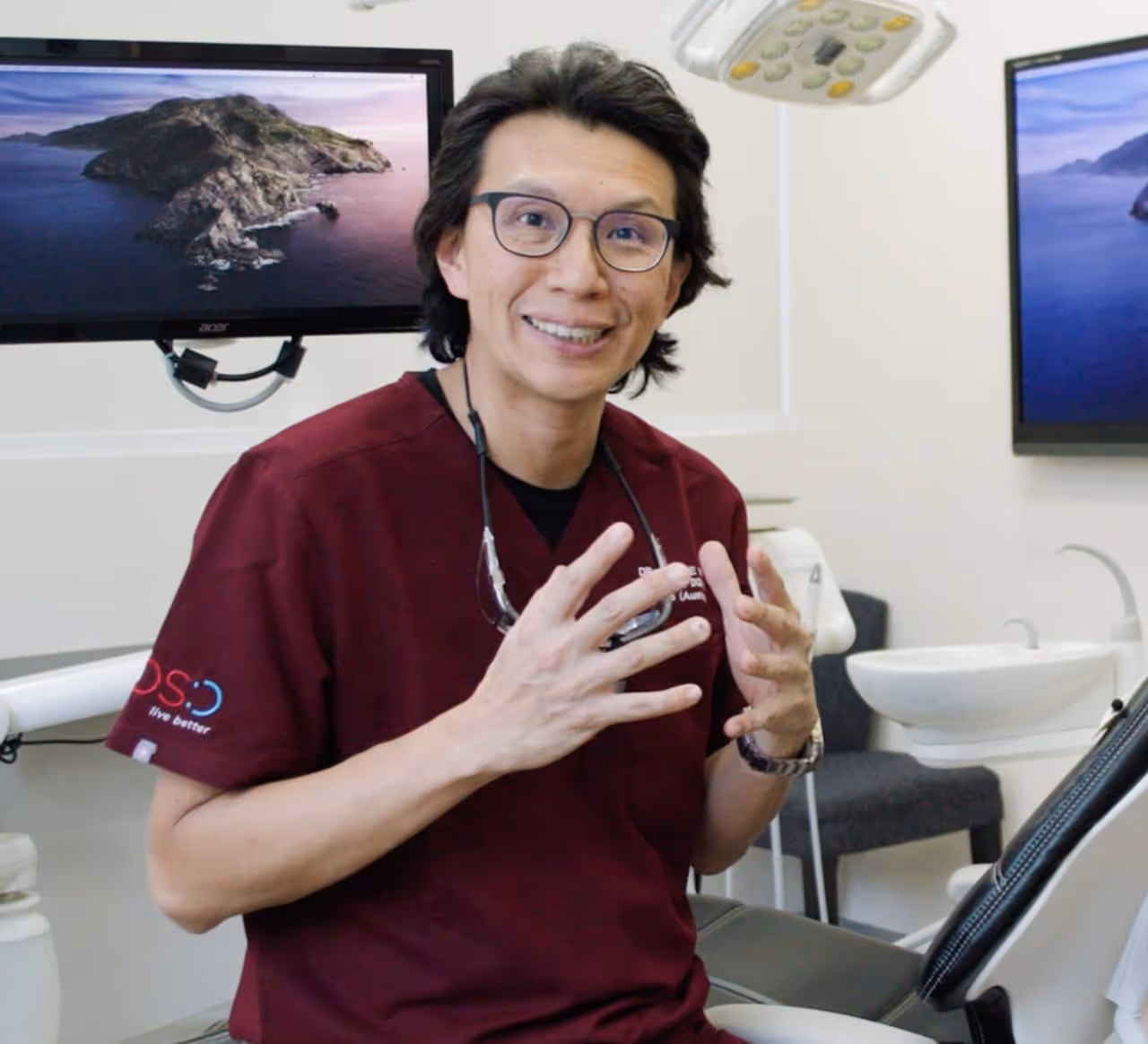 Dr. Ronnie Yap in conversation to camera excited hands in air