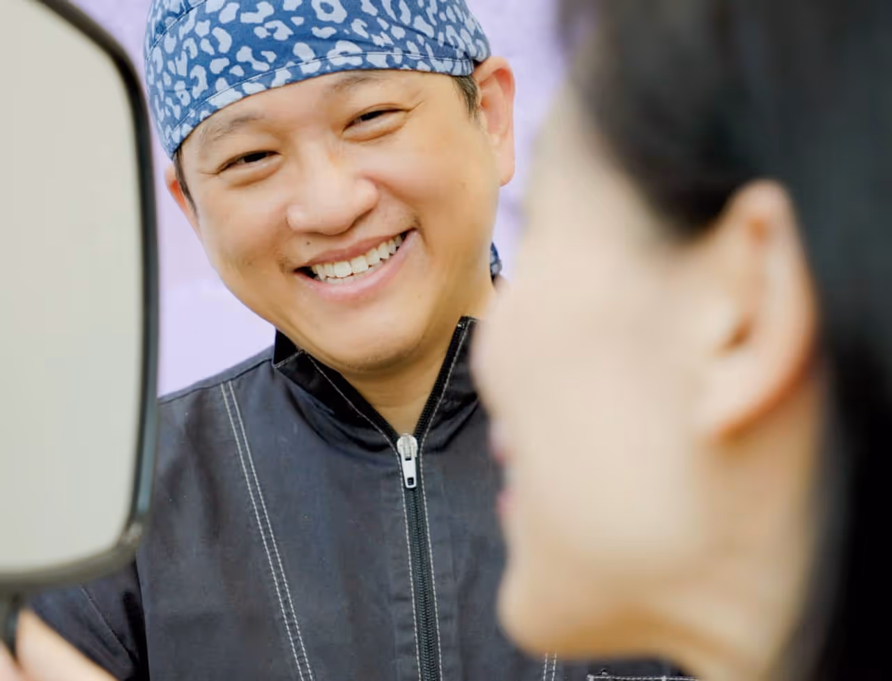 Dr. Jerry Lim smiling at Sharon Au foreground