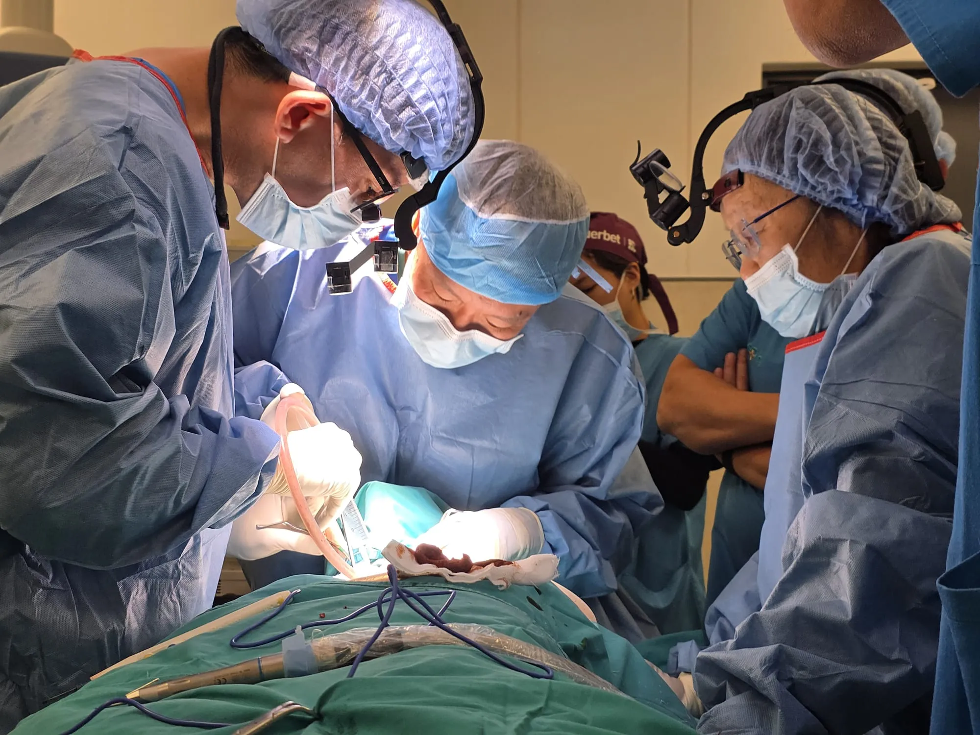 Dr. Noah Teo, Specialist Oral Surgeon at Orchard Scotts Dental performing an oral surgery